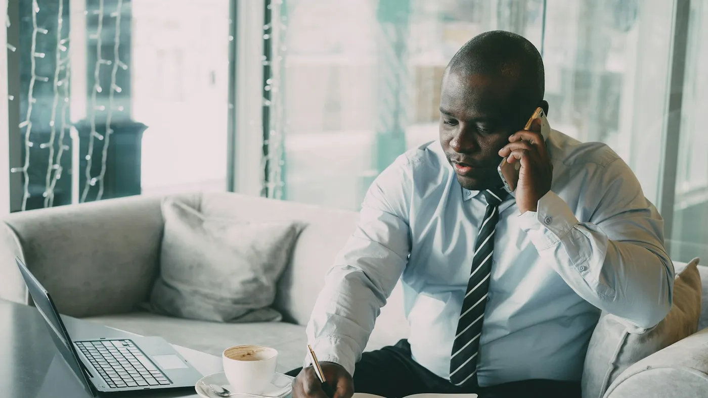 A lawyer on the phone, taking notes by hand
