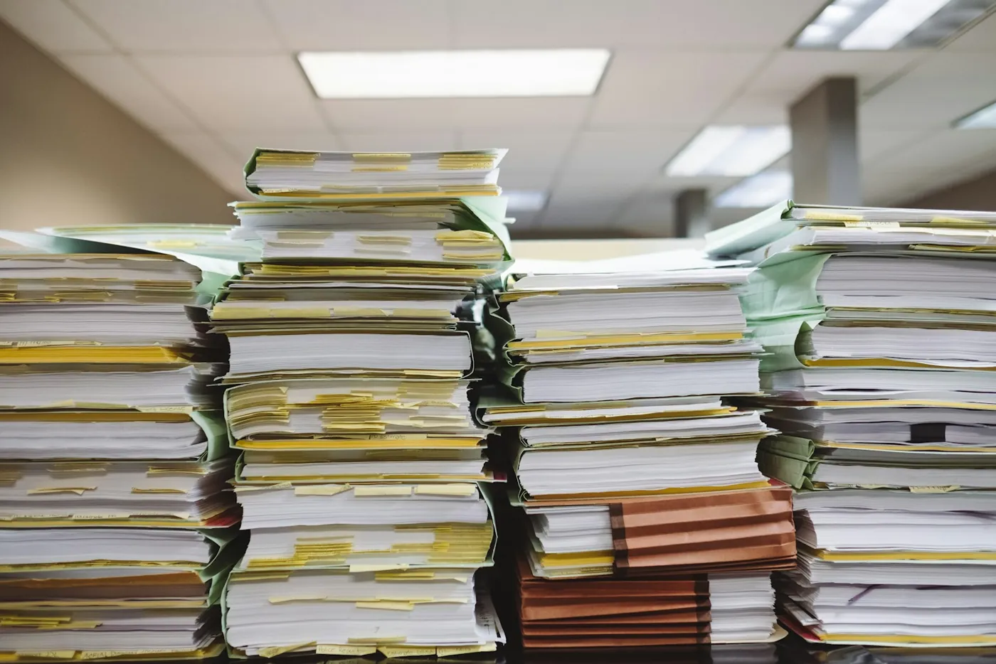 Stacks of case files on a desk