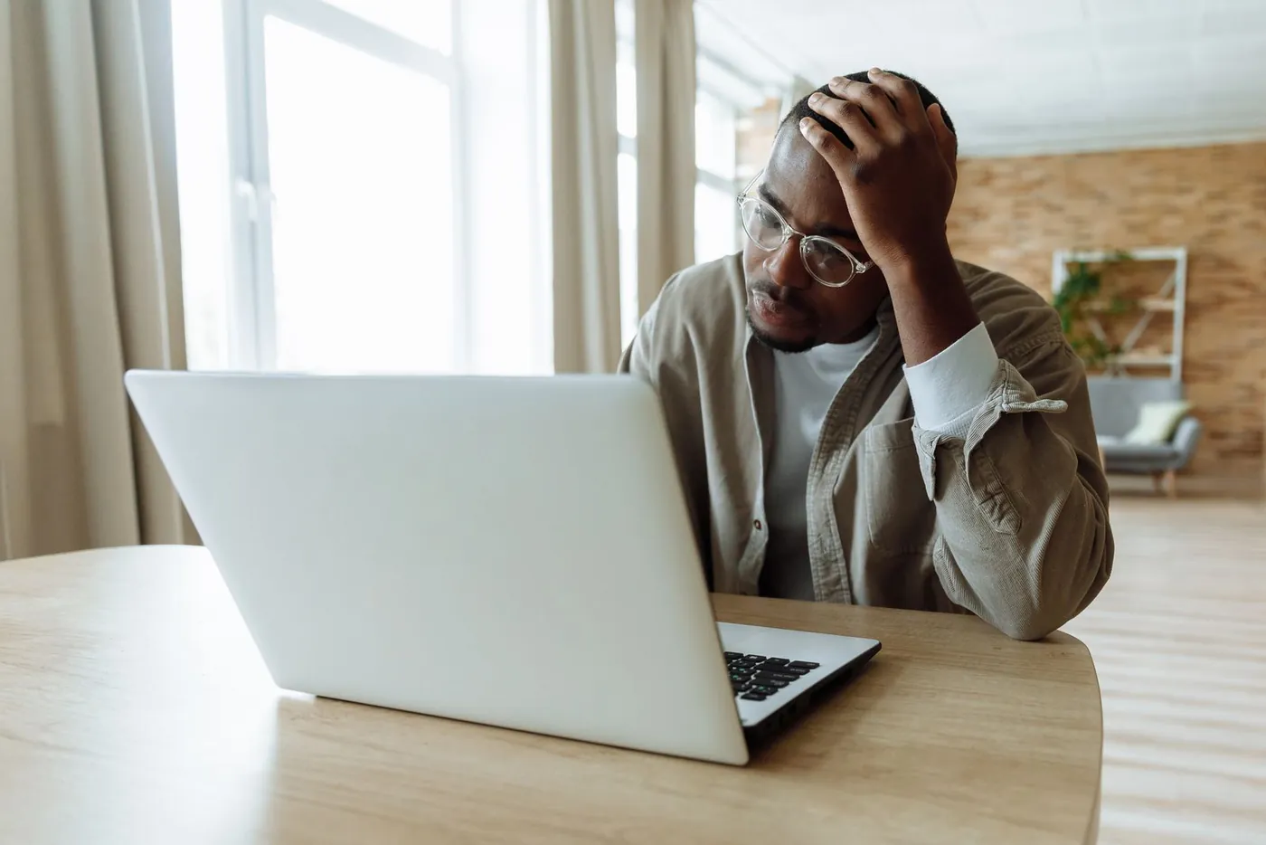 Founder at a laptop, hand on his head, looking at a codebase the previous developer left unfinished